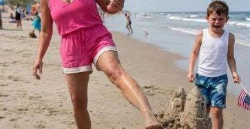 An entitled woman kicked my son’s sandcastle into the ocean because it “”ruined her view””—twenty minutes later, the lifeguard walked straight toward her carrying a golden box. My nine-year-old son, Noah, used to build sandcastles with his dad every summer. While other kids splashed in the waves, the two of them would spend hours building enormous kingdoms with moats, seashell towers, and tiny flags. Last October, my husband d:ied in a construction ac:cident. From that day on, Noah stopped smiling. The only time I saw a spark return to his eyes was when he quietly asked, “”Mom… do you think Dad can still see the sandcastles I build for him?”” I burst into tears. So this Fourth of July, I took him back to the same beach. For three straight hours, he carefully built the biggest castle we’d ever made. When he finally finished, he pulled a tiny American flag from his backpack. “”I’m putting it on the highest tower,”” he whispered. “”It’s for Dad.”” Before he could place it… a woman marched straight across the sand. Designer sunglasses. Phone already recording herself. She walked toward the shoreline, looked at our castle, and frowned “”This thing ruins the view from my beach blanket.”” Before I could react, she swung her leg and kicked straight through the tallest tower. Then another. Then another. One kick sent the entire castle sliding into the waves. Noah just stood there. Holding the little American flag he’d been about to place on the highest tower. His lip trembled. “”But…”” he whispered. “”I built it for my dad.”” The woman rolled her eyes. “”It’s just sand.”” I wrapped my arms around my son while he cried into my shoulder. About twenty minutes later, a shrill whistle echoed across the beach. Everyone turned. A senior lifeguard was walking directly toward the woman. In his hands was a golden box tied with a navy ribbon. He smiled politely. “”Excuse me, ma’am,”” he said. “”Congratulations.”” “”You’ve just been selected for today’s special beach presentation.”” Her face lit up. She reached eagerly for the box. The moment she opened it… the smile disappeared. “”What the hell is this?!”” she screamed. Thanks for reading! ❤️ There’s more to the story, but we couldn’t fit it all into this post. You’ll find the rest in the link in the comments. Head over to keep reading, and if you’re enjoying it, please leave a like, it really helps!
